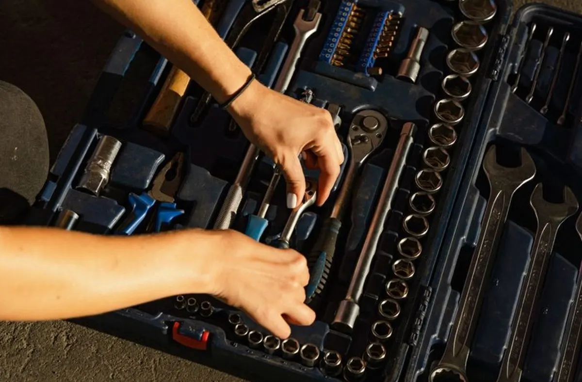 Un mécanicien qui repose un étrier de frein sur une voiture en atelier